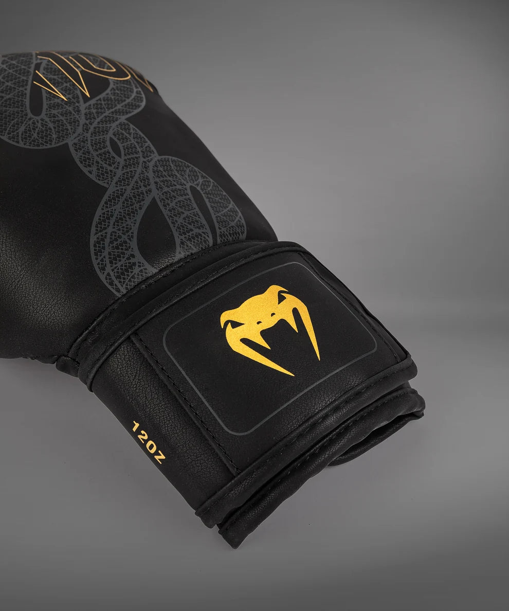 Close-up of the palm and attached thumb on a Black/Silver/Gold Venum Serpenti Boxing Glove showing the stitched inner construction