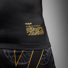 Compression fit and movement detail on Venum Serpenti Short Sleeve Rashguard Black Silver Gold