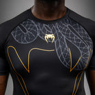 Black Silver Gold Serpenti graphic detail close-up on Venum short sleeve rashguard