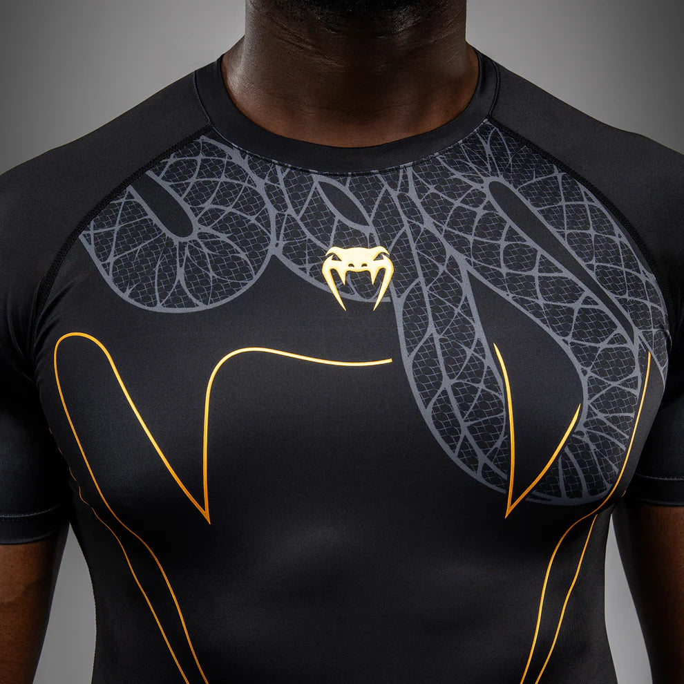 Black Silver Gold Serpenti graphic detail close-up on Venum short sleeve rashguard