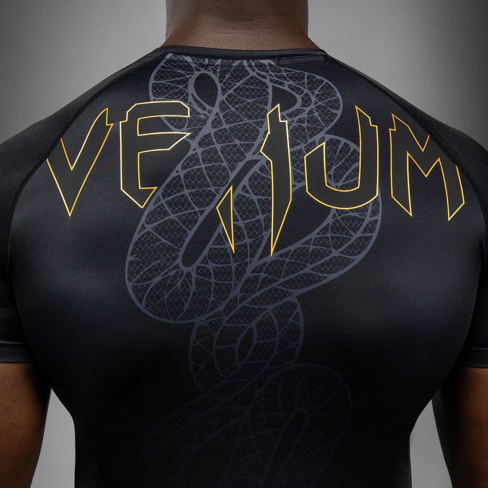Black Silver Gold Serpenti graphic detail close-up on Venum short sleeve rashguard