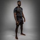 Second Side view of Venum Serpenti Short Sleeve Rashguard Black Silver Gold showing short sleeve compression fit