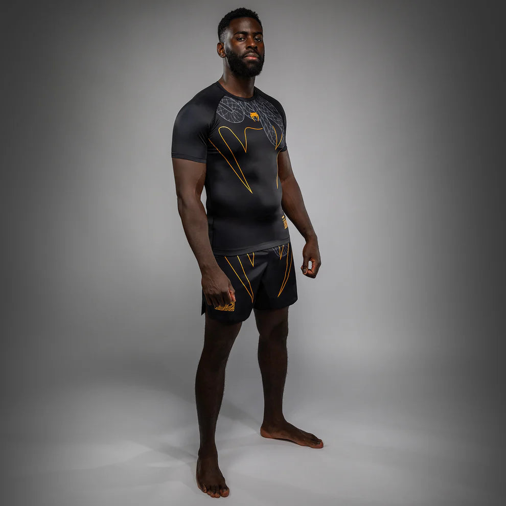 Second Side view of Venum Serpenti Short Sleeve Rashguard Black Silver Gold showing short sleeve compression fit