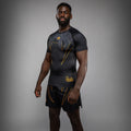Side view of Venum Serpenti Short Sleeve Rashguard Black Silver Gold showing short sleeve compression fit