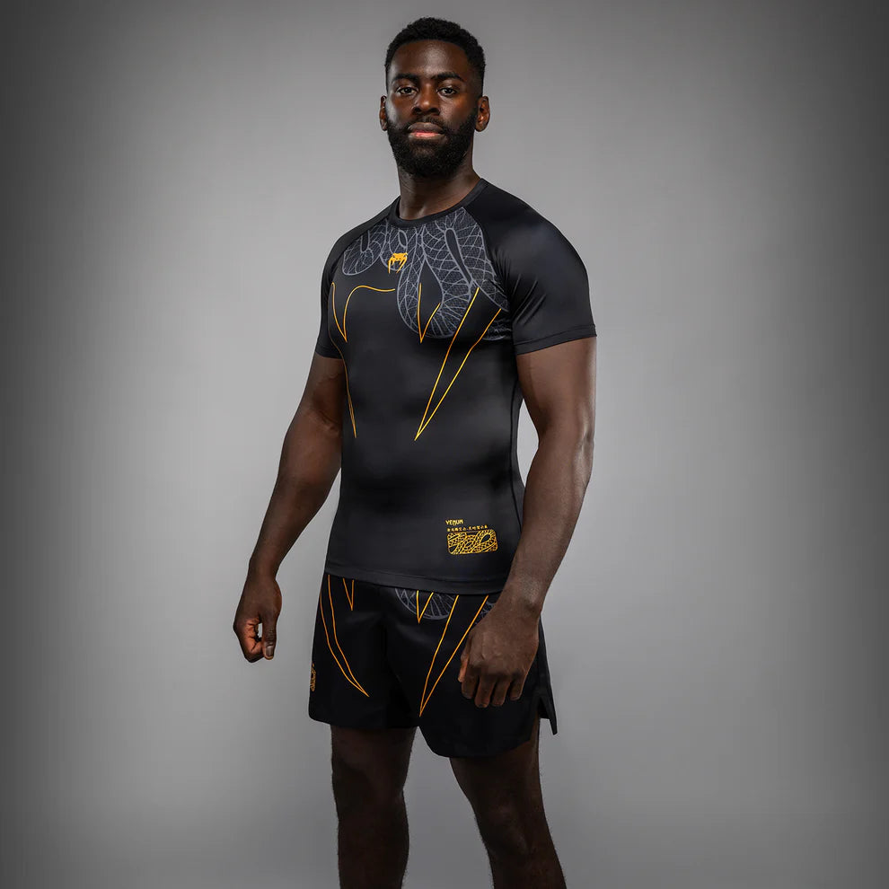 Side view of Venum Serpenti Short Sleeve Rashguard Black Silver Gold showing short sleeve compression fit