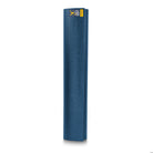 Yogi using the Warrior II Yoga Mat dark blue during floor poses, showing grip and comfort.