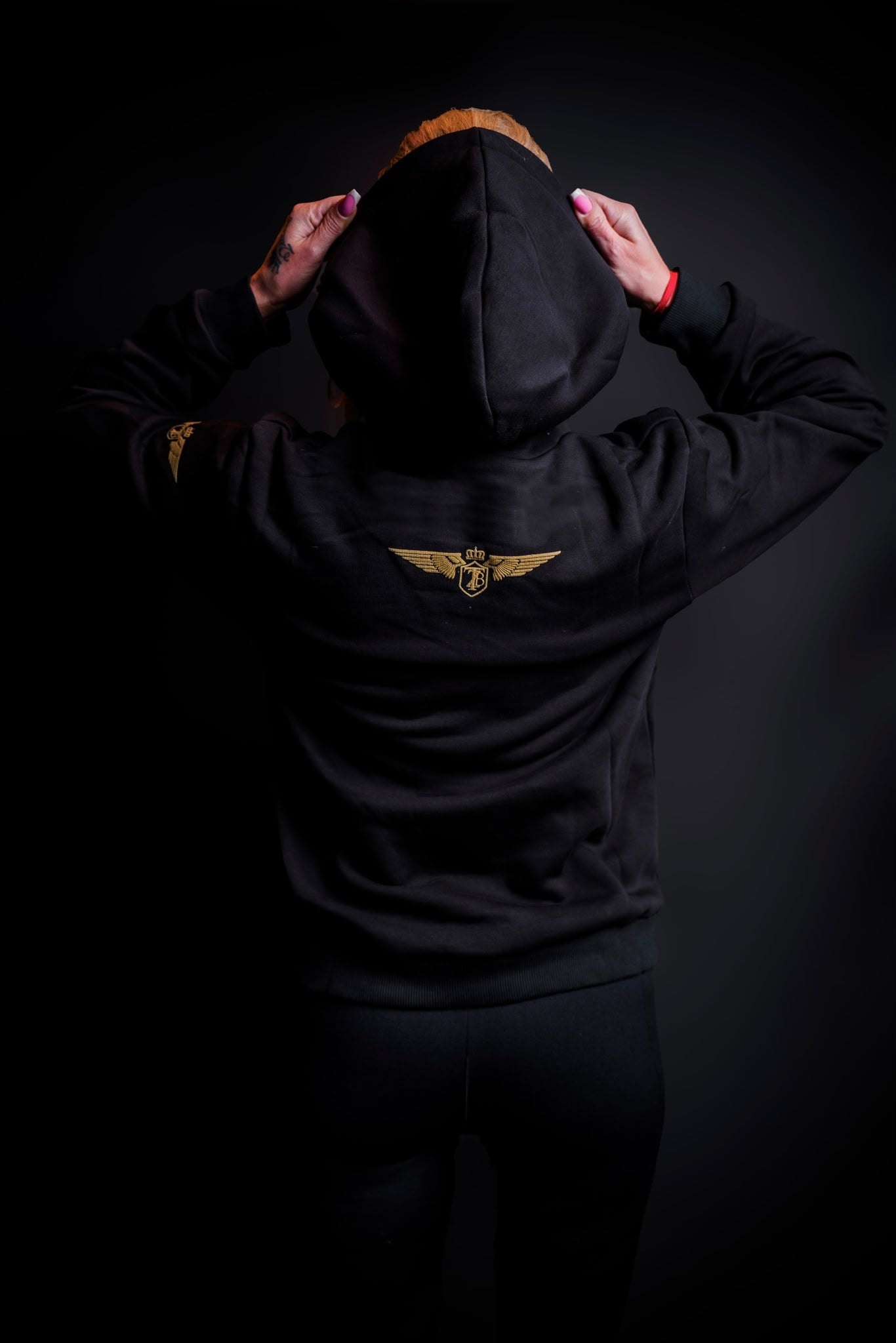 Model wearing the Zander Premium Cotton Training Hoodie in a casual athletic setting
